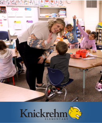  teacher giving a kindergarten student a high five